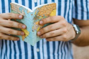 Antelope Canyon Tours - Articles 29 man holding world map book